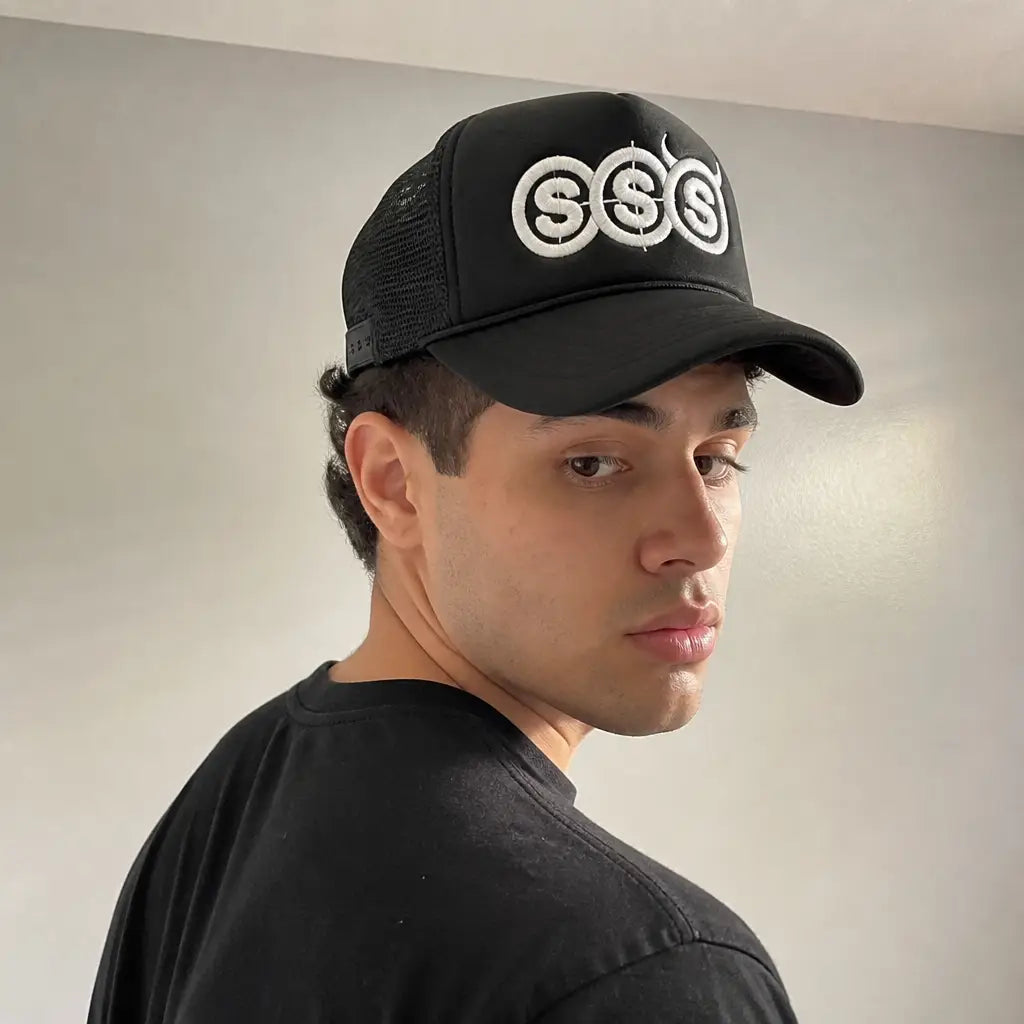 Side view of the SSS trucker hat on a model showing the black mesh panels and snapback