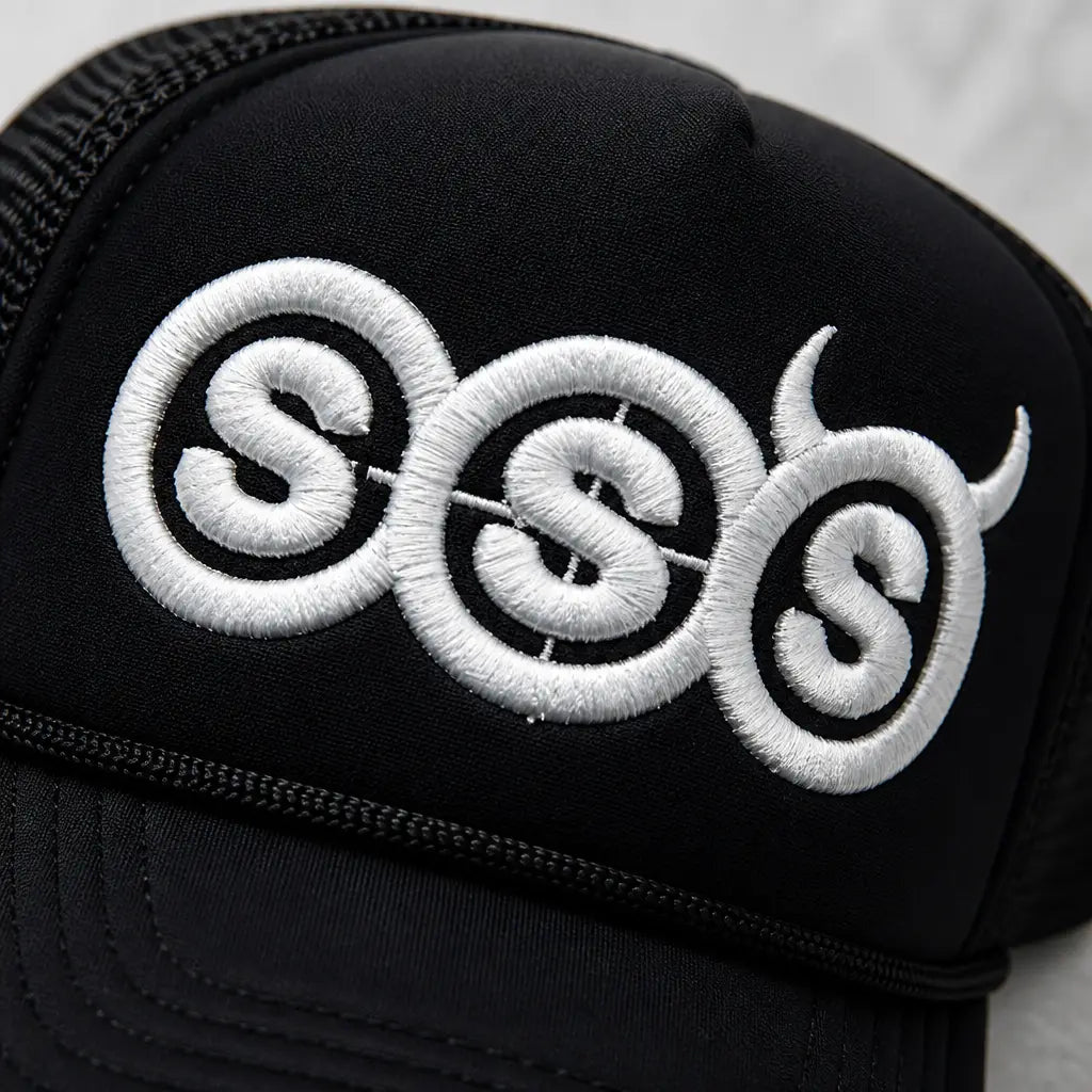 Close-up of the raised white 3D puff SSS embroidery on black foam