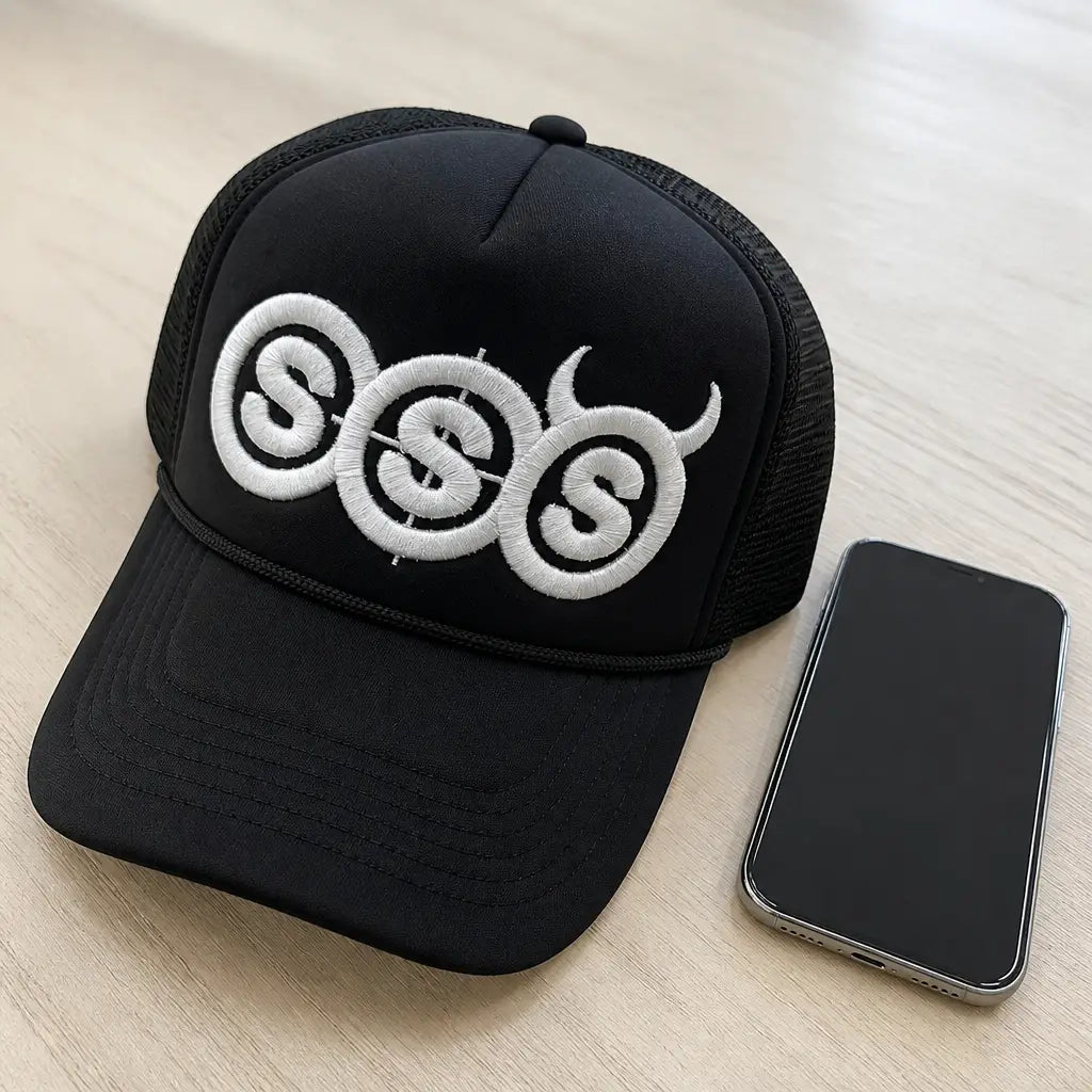 The trucker hat next to everyday objects to show its real size