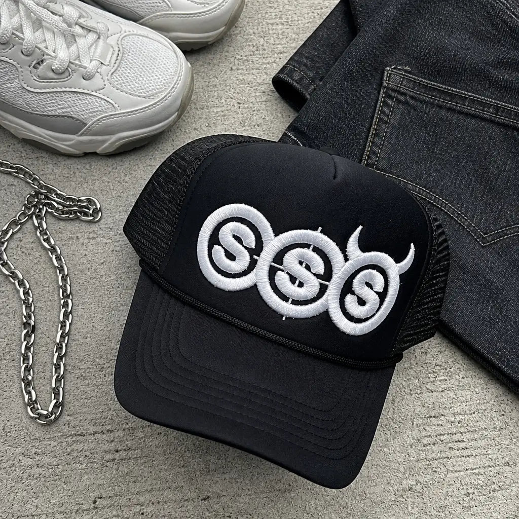 The hat laid flat with everyday streetwear items
