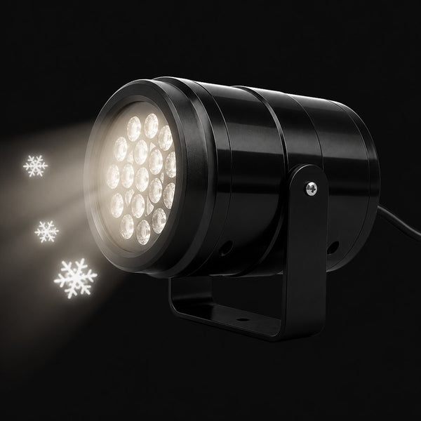 Snando snow projector with its lens glowing and snowflakes drifting forward