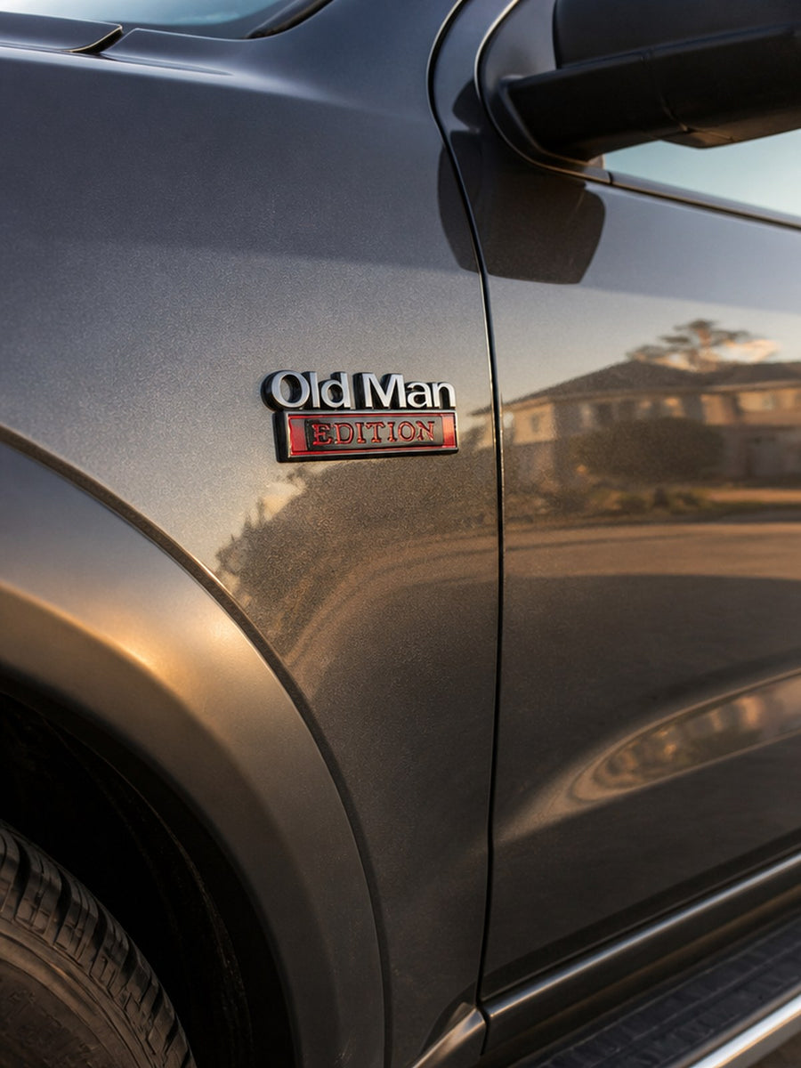 Snando Old Man Edition badge on a truck fender, next to the factory trim badge
